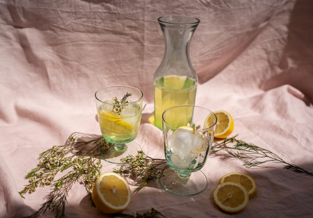 clear glass pitcher with lemon juice